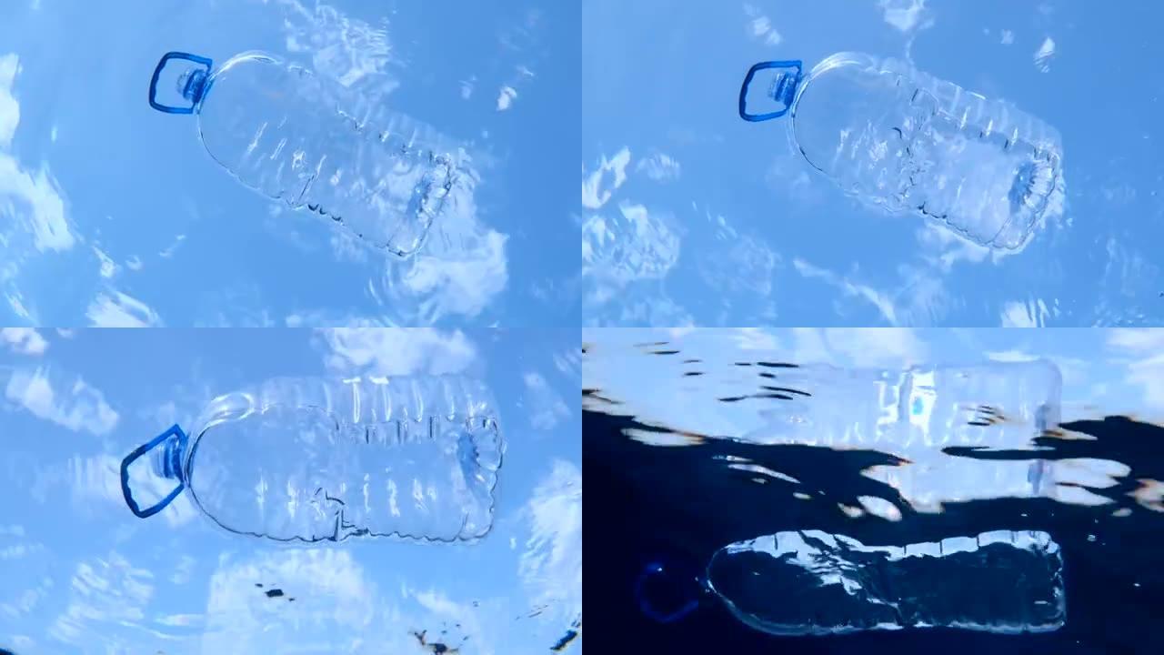 大塑料瓶漂浮在水面上，在蓝天云彩的背景上。带手柄的塑料桶在海浪上漂移。海洋的塑料污染。水下射击