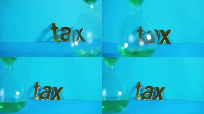 Hourglass with word "Tax" on gold colored alphabet