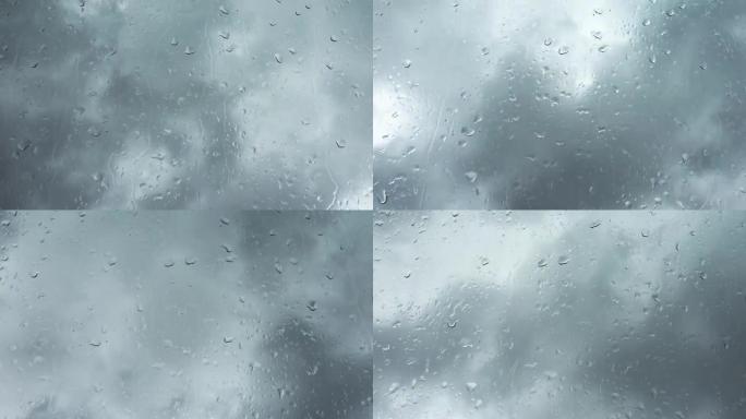 时间流逝的雨滴在玻璃窗上的乌云前。