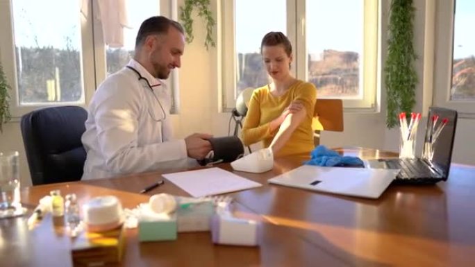 Doctor taking woman's blood pressure