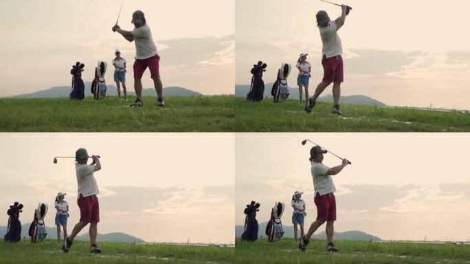 高尔夫球手的剪影扫荡并保持高尔夫球场