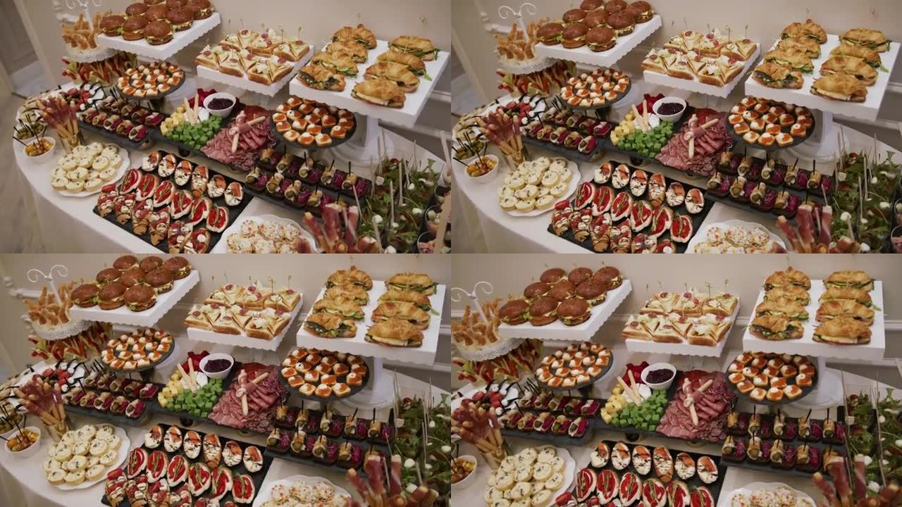 餐桌上有各种小吃: 传统小吃或派对、活动和鸡尾酒的开胃菜，在正式招待会的主餐前供应。以面包为基础，顶