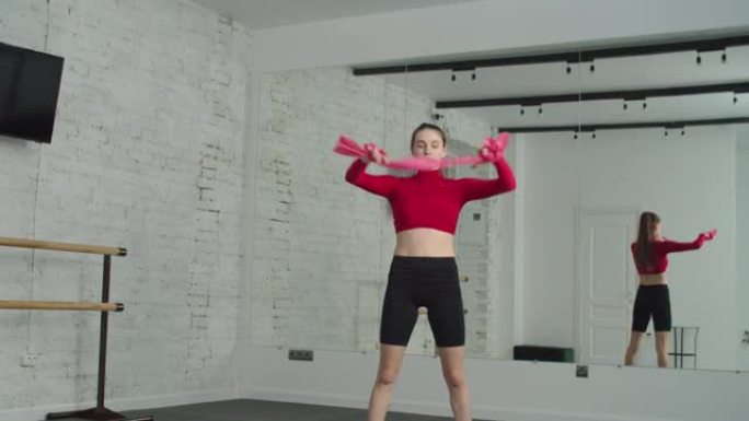 运动女性锻炼带状站立向前弯曲