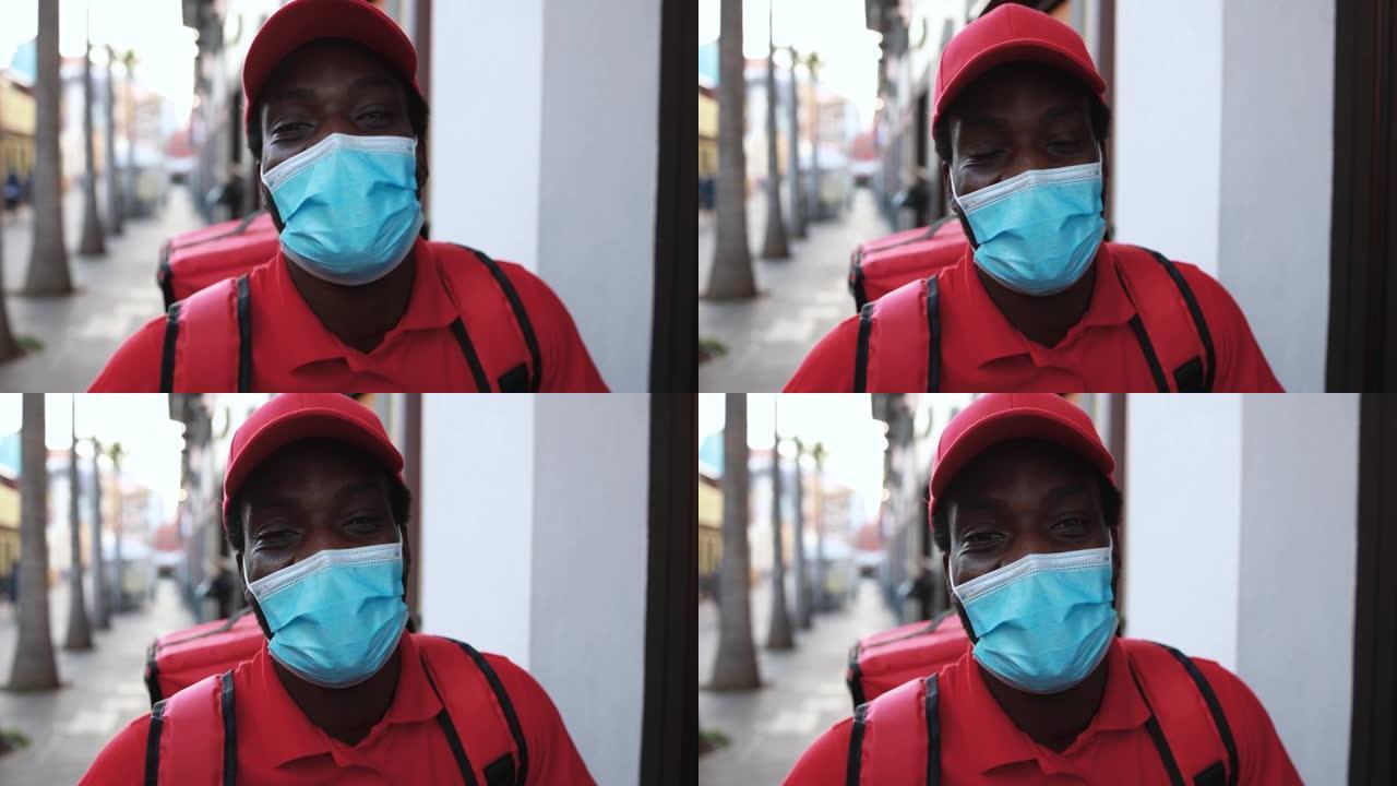非洲男子为冠状病毒疫情戴安全口罩为送餐工作