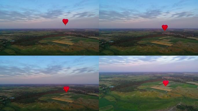 恋爱心形的红色气球。自然景观和美丽热气球的全景。明亮的浮空器在田野上空飞行。