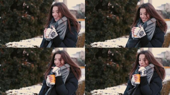 快乐女孩在冬季公园散步时喝咖啡外卖