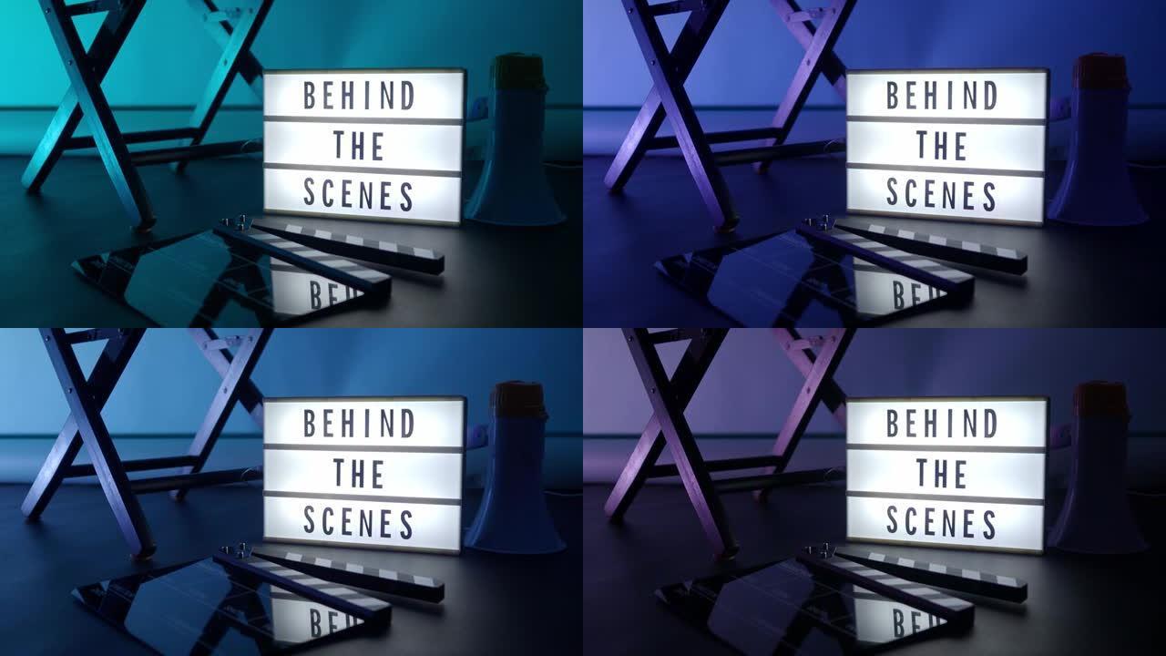 幕后在演播室变色背景灯灯箱上的信板文字。电影灯箱旁边的电影石板隔板扩音器和导演椅。视频制作电影概念。