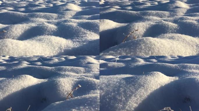 令人敬畏的冬季场景。雪纹理特写。雪表面的微观纹理。冰晶和雪花闪闪发光。雪地里的乡村田野。从太阳倾泻温