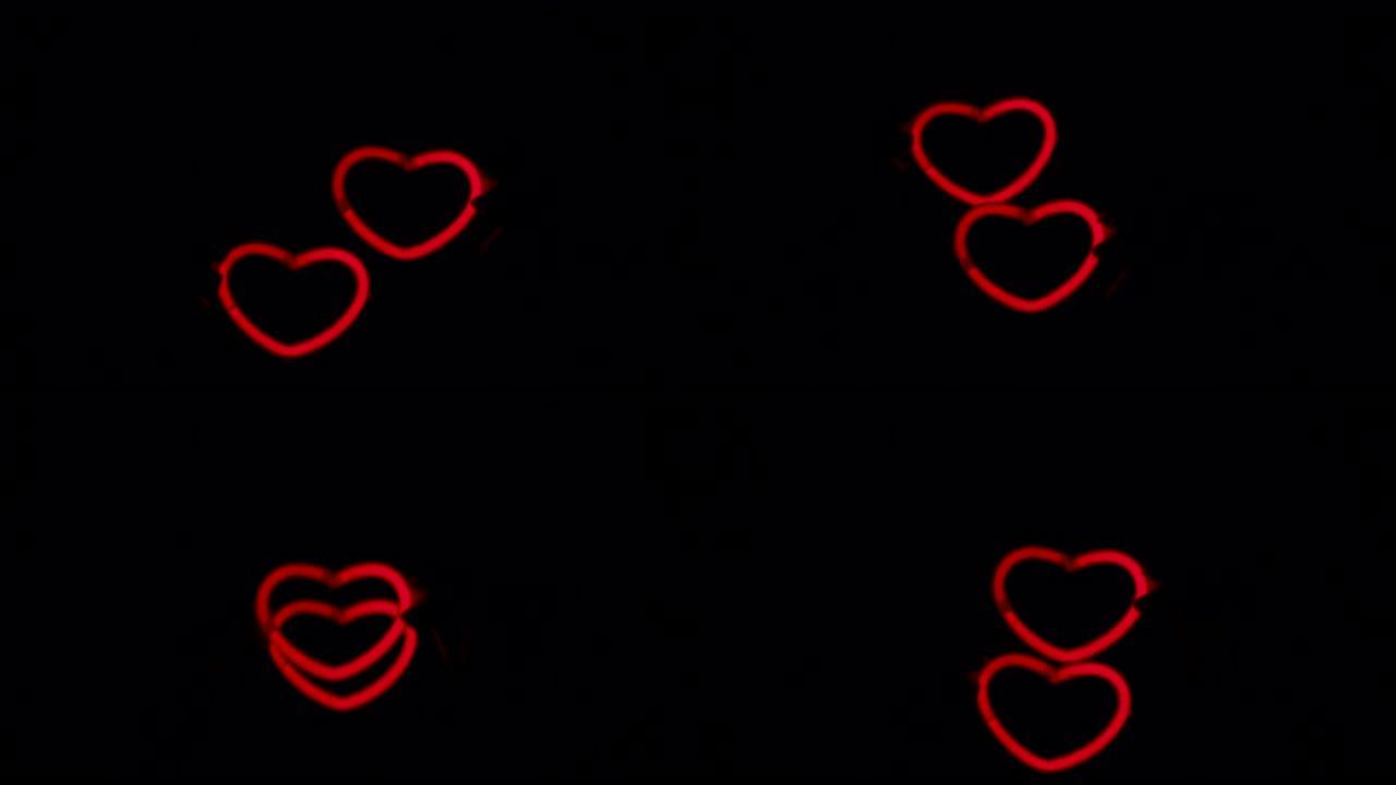 黑色背景上的红色霓虹灯心。两颗霓虹灯的心一起跳舞。