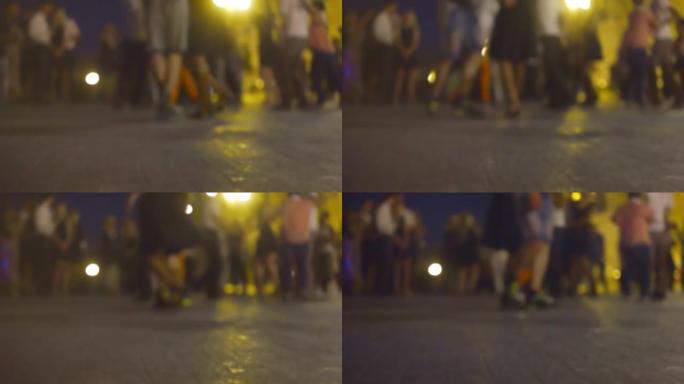 散焦的年轻人在夜街上跳舞莎莎舞