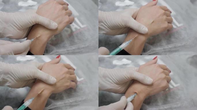 美容师将注射剂插入患者的手掌。