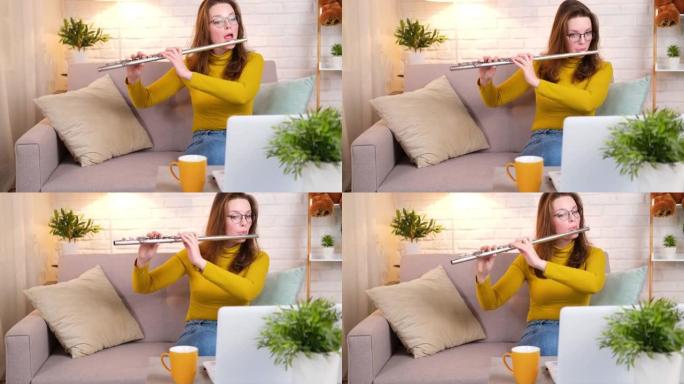 音乐老师在视频通话的课程中演奏长笛。