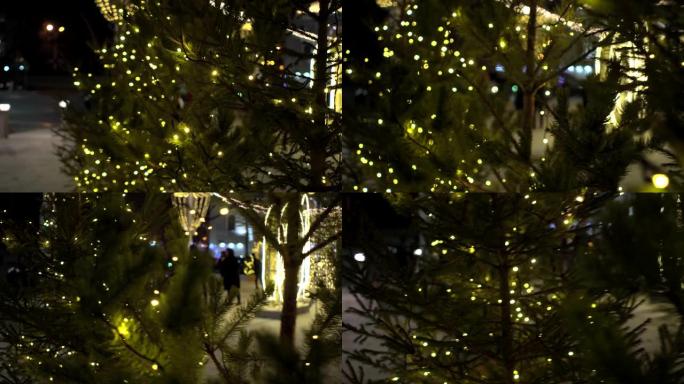 集市上的圣诞树上的花环的魔术黄色模糊的灯光