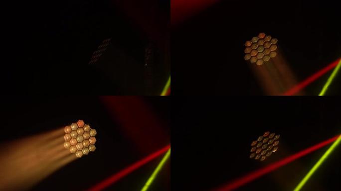 五颜六色的舞台灯。白色聚光灯和黄色红色激光全息图旋转，转动并发出明亮的光束。表演或迪斯科时的照明设备