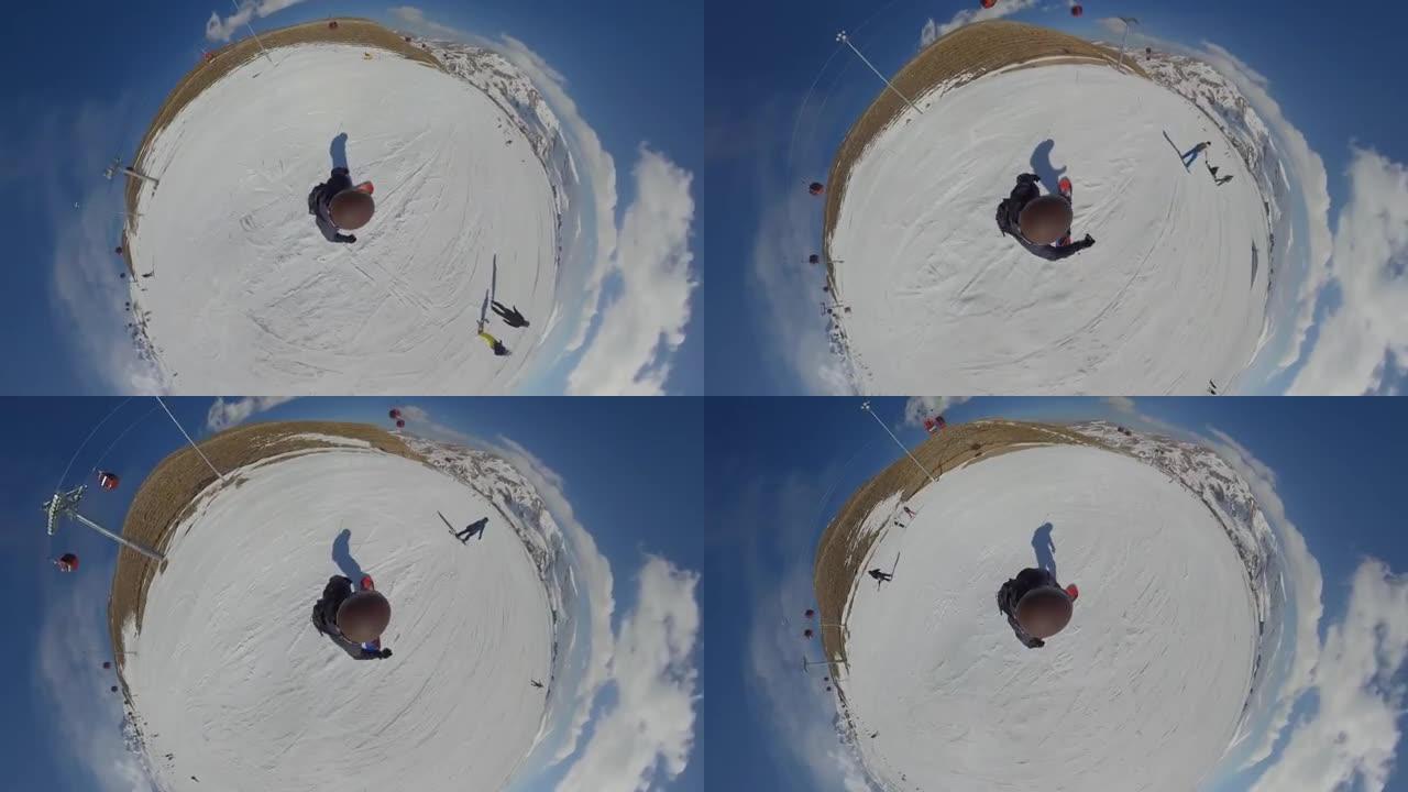 一个骑着滑雪板从山上下来的运动员。360VR:从上面看