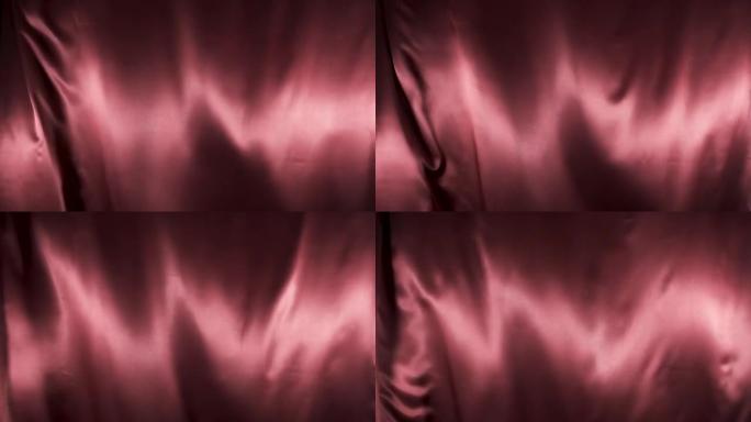 红色织物在风中飘扬。慢动作。波浪形缎纹织物在风中飘扬。抽象丝缎面料