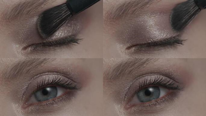一个女孩的特写镜头用化妆刷用眼影画她的眼睛。