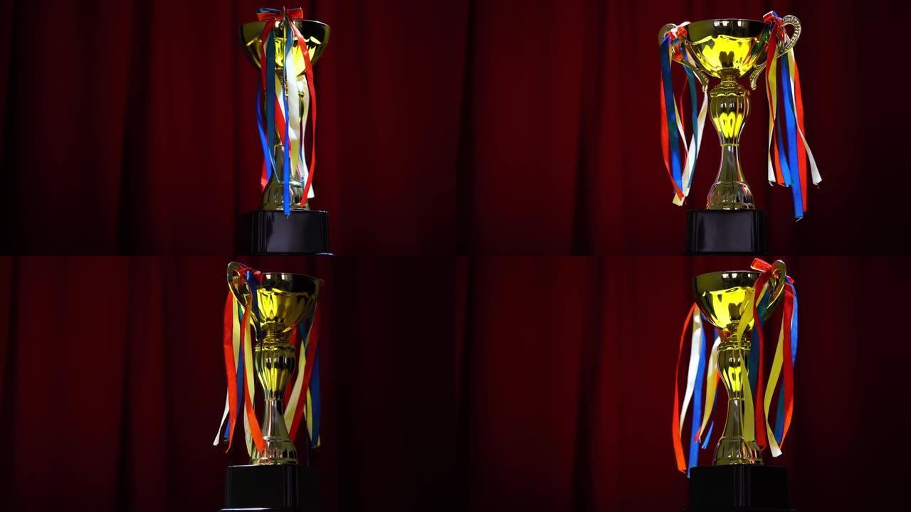 获胜者概念金奖杯放在红色窗帘舞台背景上。