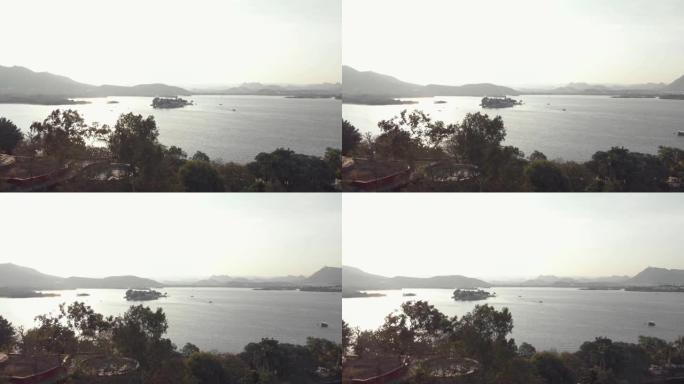 印度乌代浦湖畔城市皮丘拉湖泰姬陵湖宫殿的4k航拍画面。