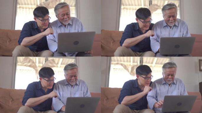 资深父亲和他的小儿子在家里使用笔记本电脑