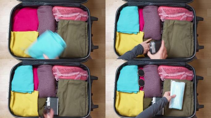 女人的手在手提箱里装着旅行用的东西，还有防护口罩。顶视图。