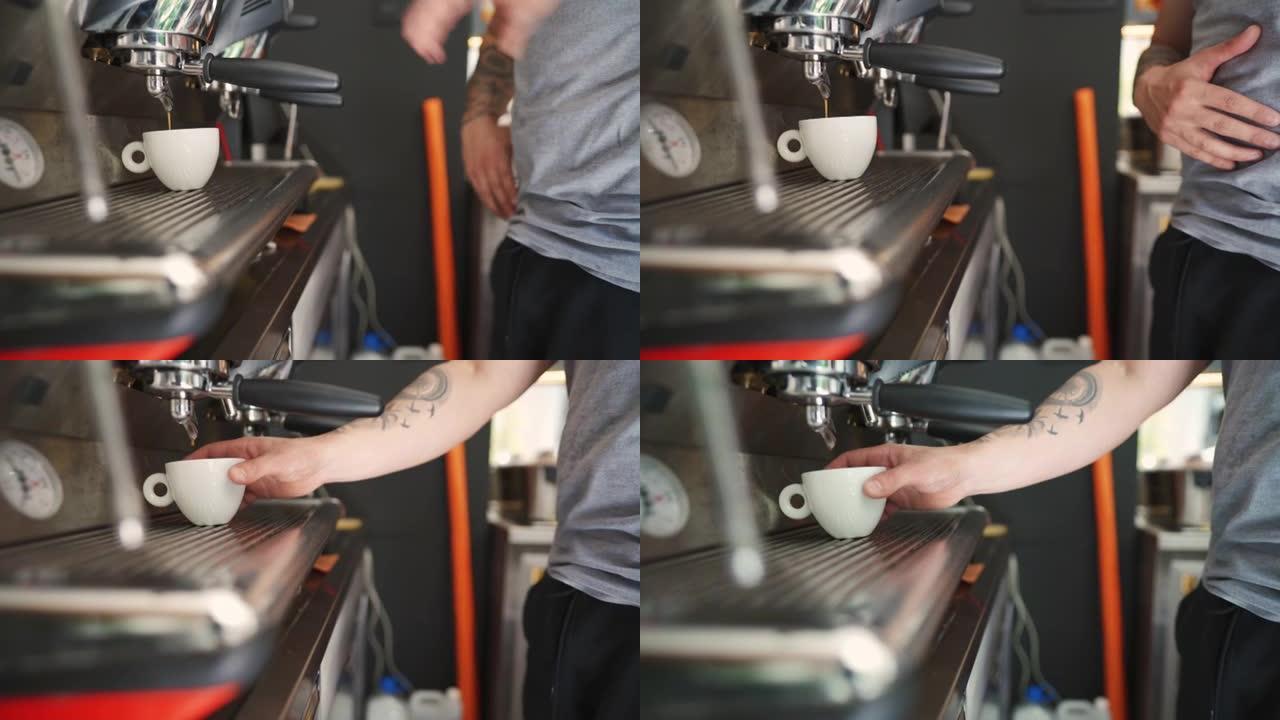 无法识别的男性咖啡师使用咖啡机准备一杯咖啡