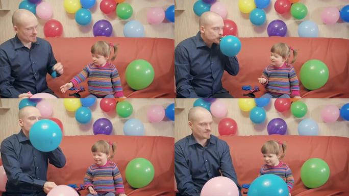爸爸和女儿给气球充气，和他们一起玩。他们满足和快乐