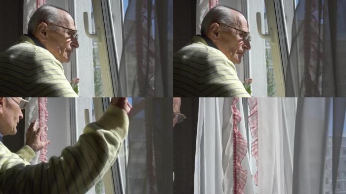戴眼镜的老人欣赏站在窗前的城市景观