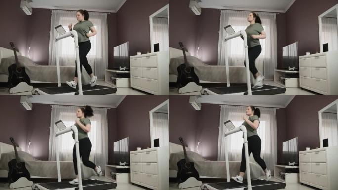 迷人的白人妇女正在家里的跑步机上跑步，做健身运动。在家进行健身锻炼。女性正在卧室里训练机器。有氧运动