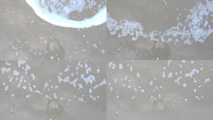 海浪卷起白色沙滩的特写镜头，大海、海浪和沙滩的视频