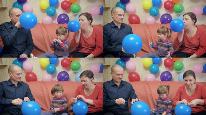 爸爸，妈妈和小女孩蓝色充气气球过生日