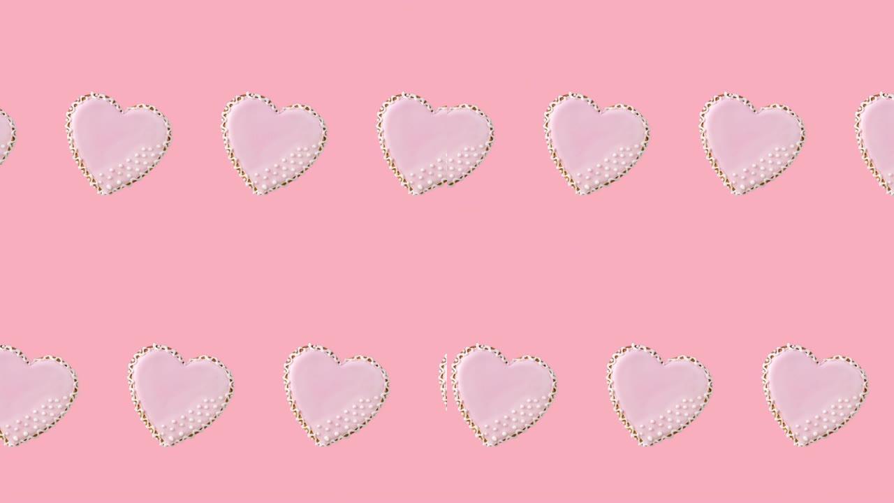 无缝循环动画，一排心形饼干由粉彩釉装饰在柔和的背景上