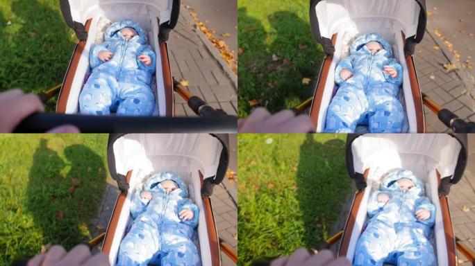 妈妈手握婴儿车手柄。母亲带着婴儿在婴儿车里散步。现代婴儿车里的孩子。特写镜头。