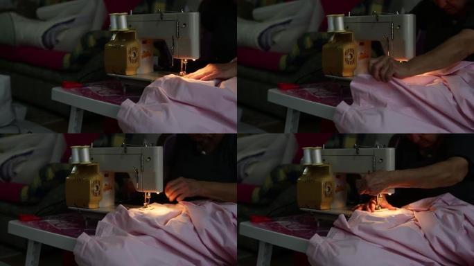 一个女人在缝纫机上的被套上做扣眼