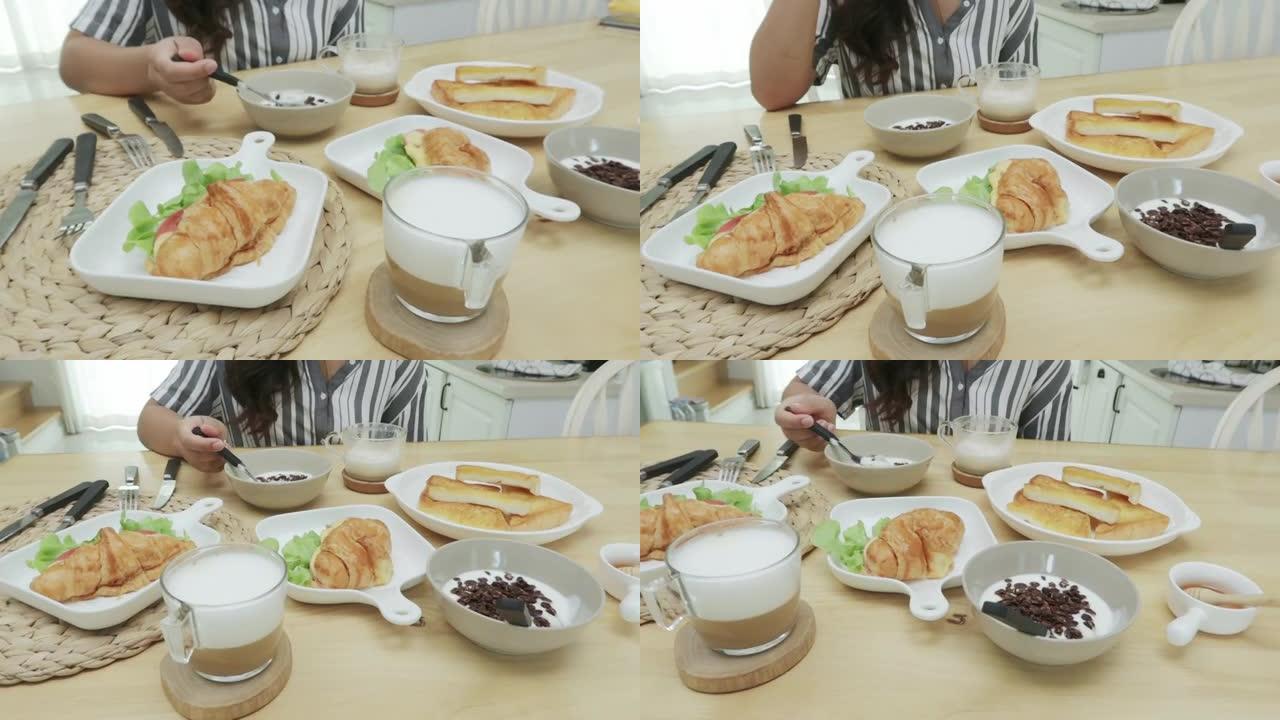 餐桌上的概念快餐，羊角面包，面包，酸奶，餐桌上的咖啡具即可食用。