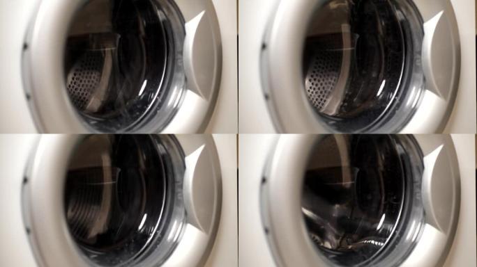 旋转滚筒洗衣机的特写视频。