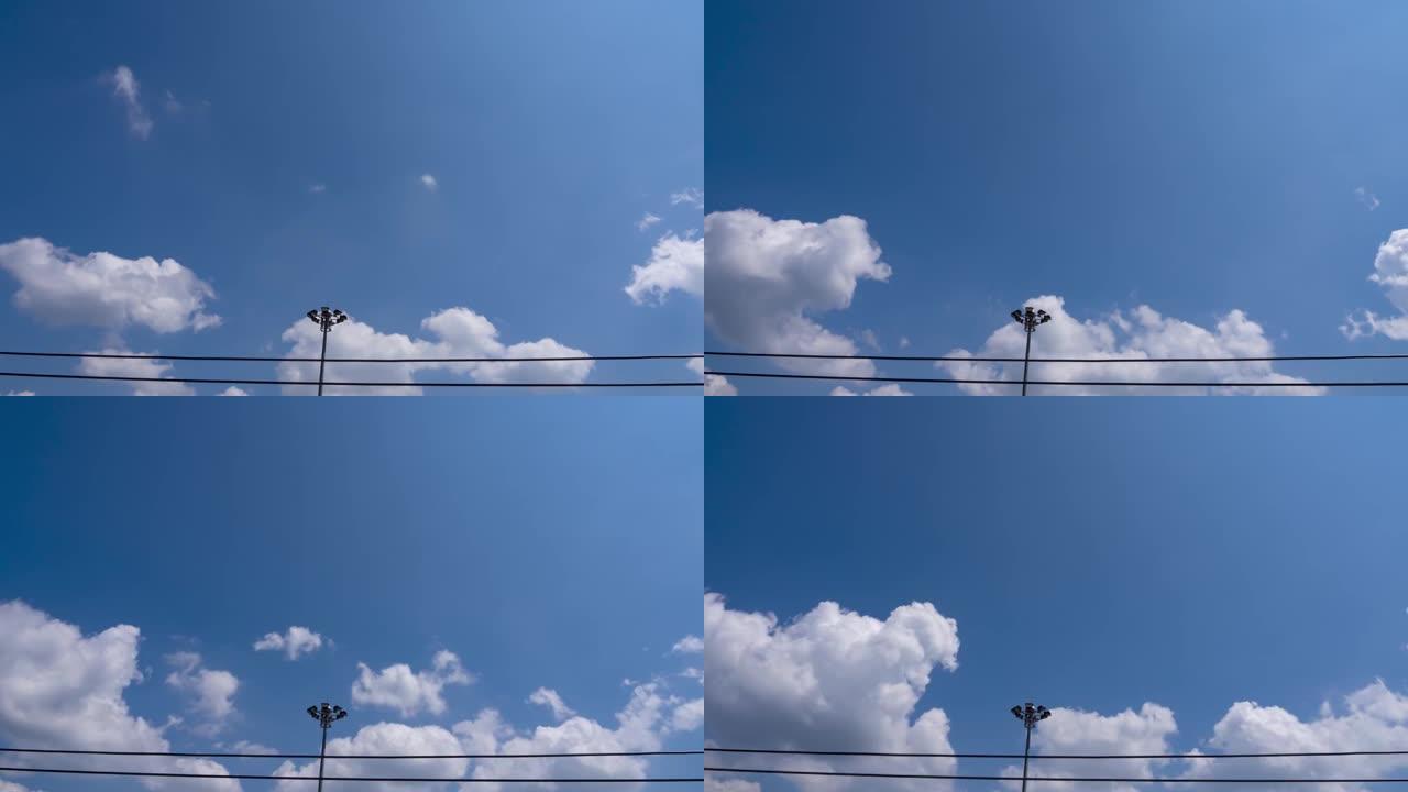 白天的蓝天广阔空间。白色蓬松的棉花糖云慢动作通过电线移动。白天环境好，晴好天气预报。B滚动镜头