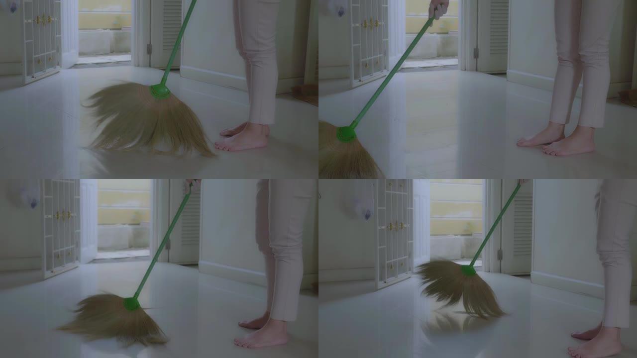 妇女们用扫把在屋里扫地