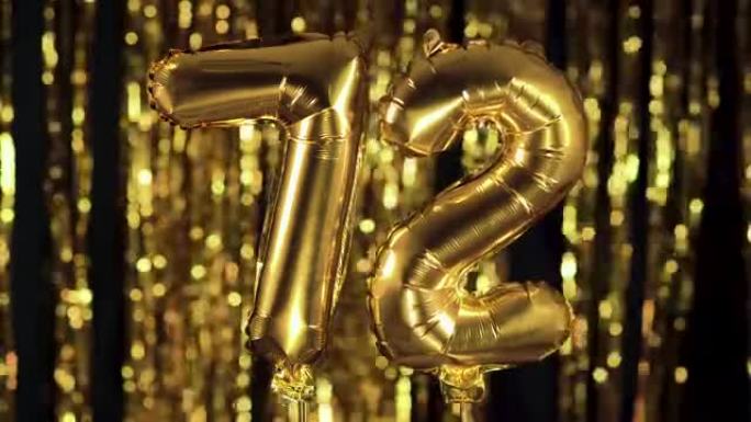 金色数字72七十二是由黄色背景上的充气气球制成的。一组完整的数字。生日、周年纪念日、日期概念