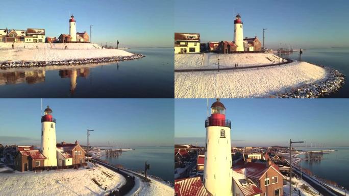 Urk荷兰灯塔冬季积雪覆盖海岸线，Urk景观灯塔冬季荷兰天气
