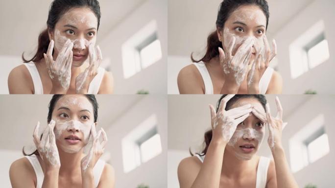 美丽的亚洲女性用水洗脸。