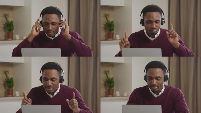 年轻的成年非洲裔美国男子拿起音乐耳机，在笔记本电脑前开始跳舞