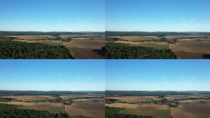 收割后的麦田和法国勃艮第涅夫勒村的Cuncy les Varzy村的绿色森林，夏季和晴天的无人机。