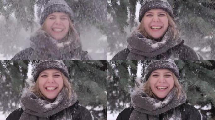 一位年轻女子的肖像，雪从上方的树枝上掉下来。
