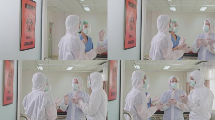 一群穿着个人防护用品的亚洲医生在医院急诊室工作。对COVID感染的患者进行成功的急救和治愈后，专业的