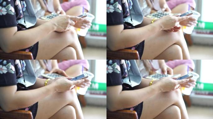 两名亚洲女性使用您的智能手机进行在线购物