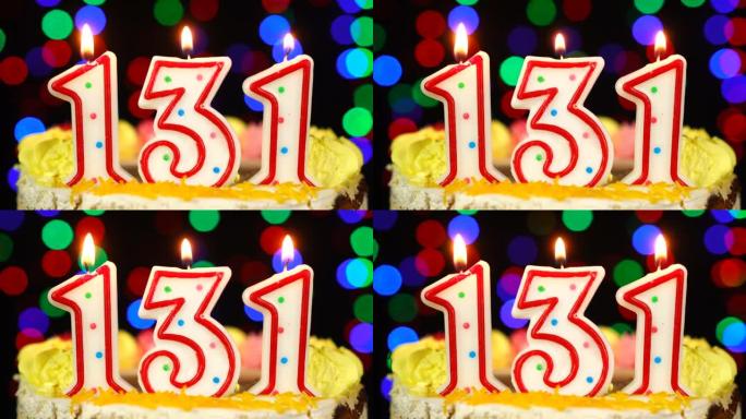 131号生日快乐蛋糕与燃烧的蜡烛顶。