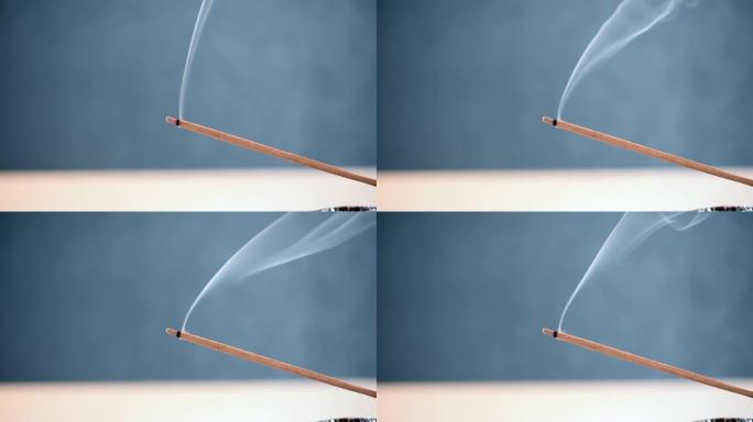 燃烧香气棒，白烟，蓝色背景特写，高清视频