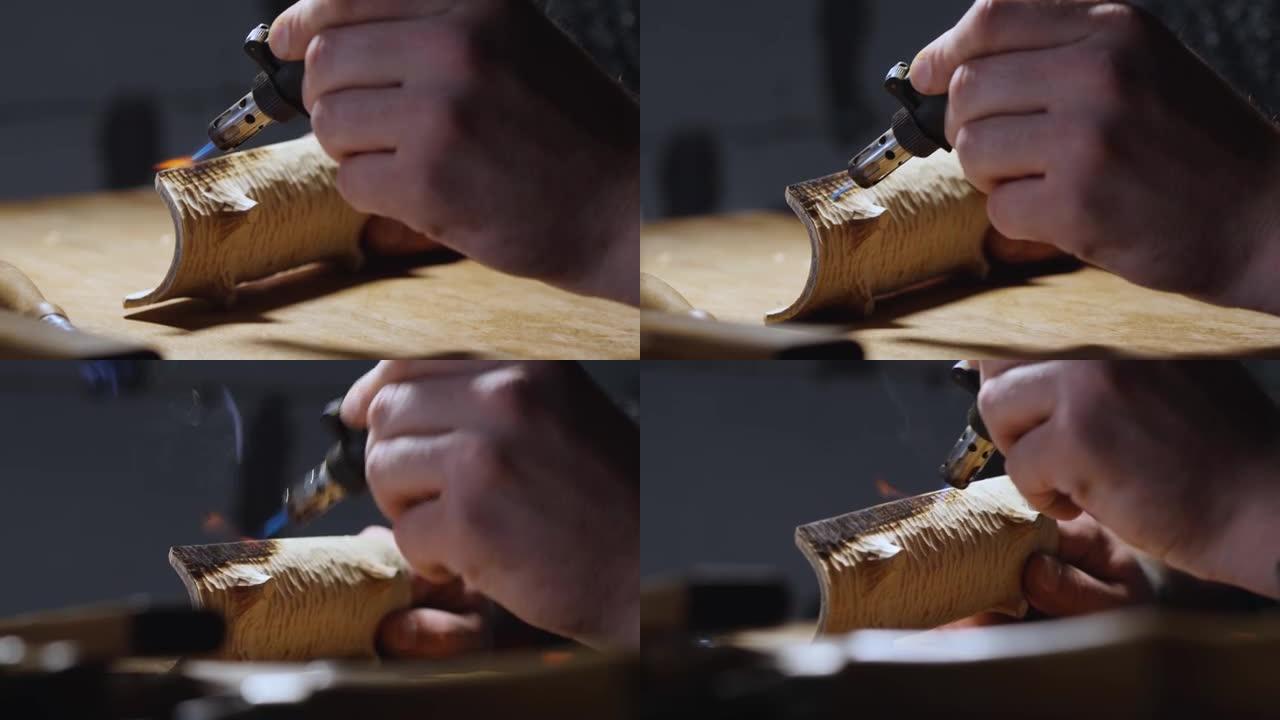 木匠用燃烧器烧掉一个木制茶架。木工艺术。手工制作的概念