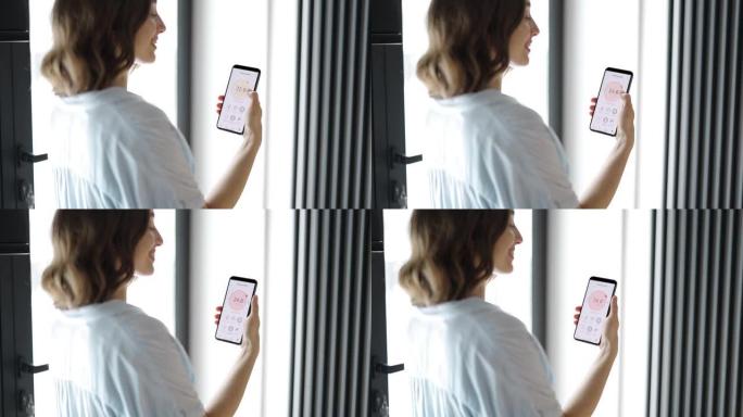 女人用智能手机调节室温